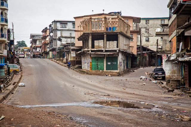 Empty streets are seen, as Sierra Leone government enforces a three day lock down on movement of all people in an attempt to fight the Ebola virus, in Freetown, Sierra Leone, Friday, Sept. 19, 2014. Thousands of health workers began knocking on doors across Sierra Leone on Friday in search of hidden Ebola cases with the entire West African nation locked down in their homes for three days in an unprecedented effort to combat the deadly disease. (AP Photo/ Michael Duff)